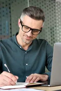 a man writing on a paper